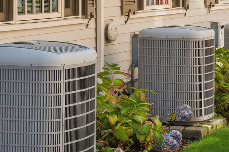 Two AC units outside a home.