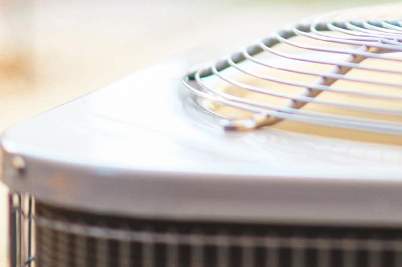 Close up of the top of a heat pump air conditioner unit.